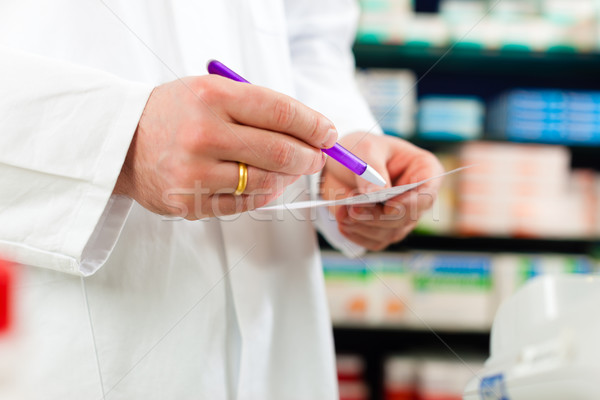 Pharmacist prescription slip in pharmacy Stock photo © Kzenon
