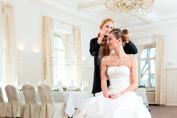 Stylist pinning up a bride's hairstyle Stock photo © Kzenon