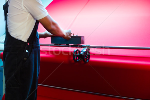 Asian worker controls fabrics in textile plant Stock photo © Kzenon