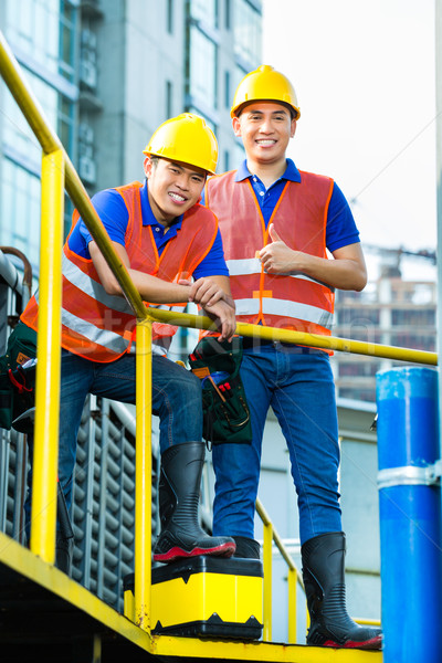 Asian Indonesian construction workers on building site Stock photo © Kzenon