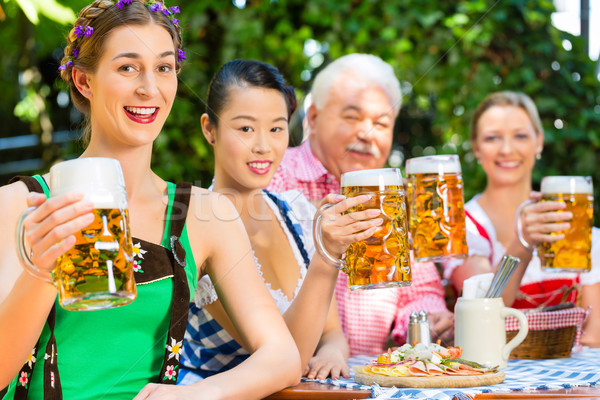 In Beer garden - friends drinking beer in bavaria Stock photo © Kzenon