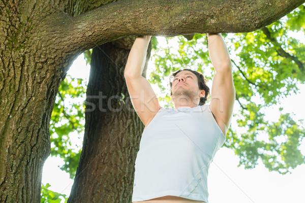 People in city park doing chins or pull ups Stock photo © Kzenon