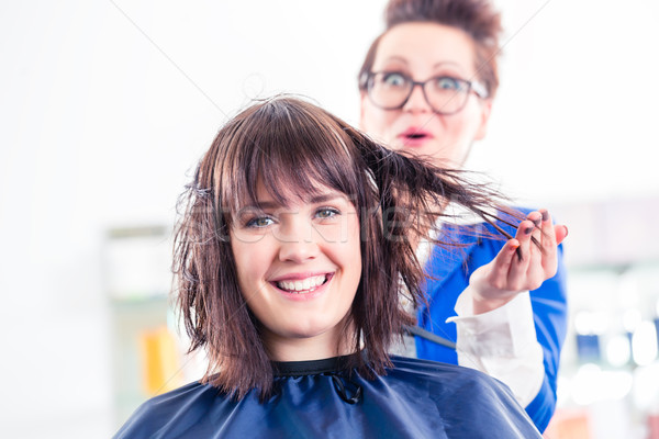 Hairdresser blow dry woman hair in shop Stock photo © Kzenon