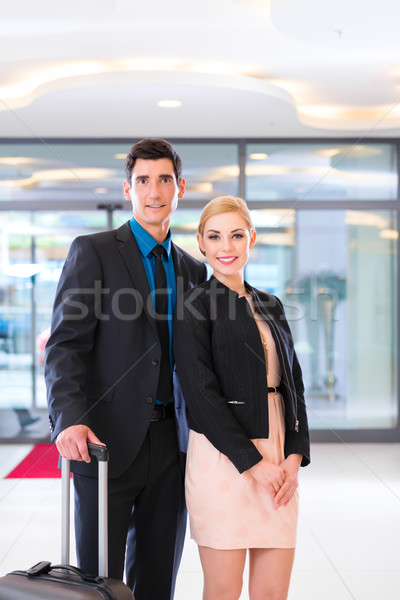 Man and woman arriving at hotel lobby with suitcase  Stock photo © Kzenon