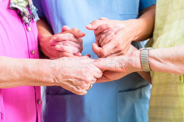 Elderly care nurse with two senior women Stock photo © Kzenon