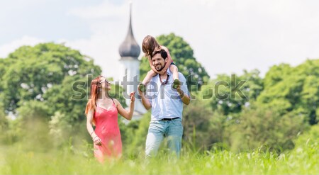 Mann turning woman dancing in the grass in summer park Stock photo © Kzenon