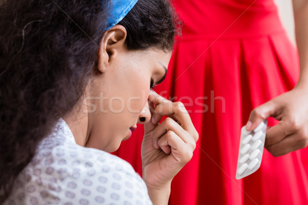 Woman giving medication against headache Stock photo © Kzenon