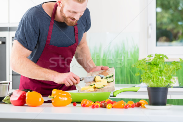 Man preparing food for cooking in kitchen Stock photo © Kzenon