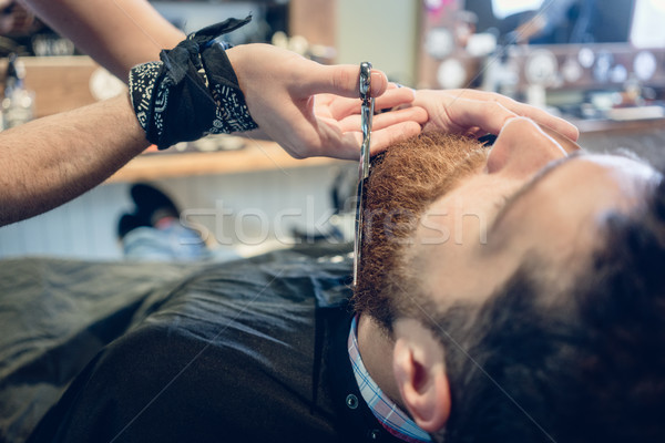 Close-up of the hand of a barber using scissors while trimming t Stock photo © Kzenon