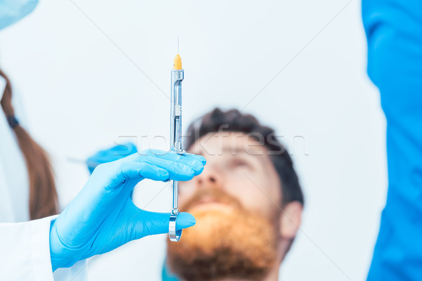 Close-up of the hand of a female dentist holding a dental anesthetic Stock photo © Kzenon
