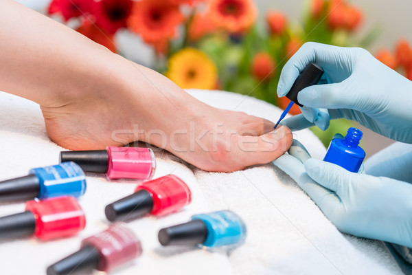 Hands of a nail technician polishing the toenails of a woman Stock photo © Kzenon