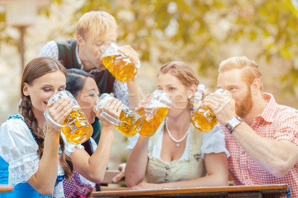 Friends drinking beer in beer garden  Stock photo © Kzenon