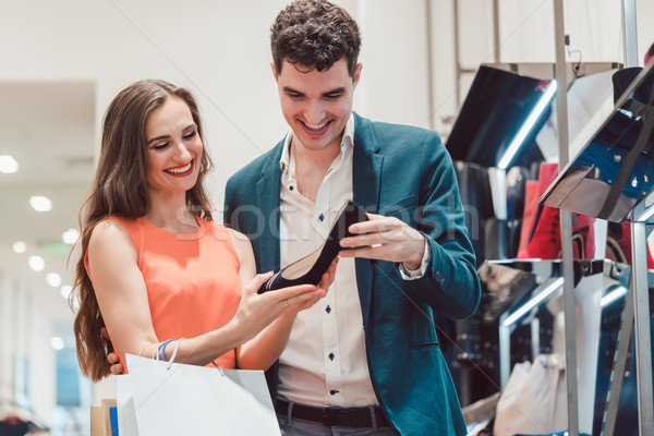 Man and woman thinking about buying pair of shoes Stock photo © Kzenon