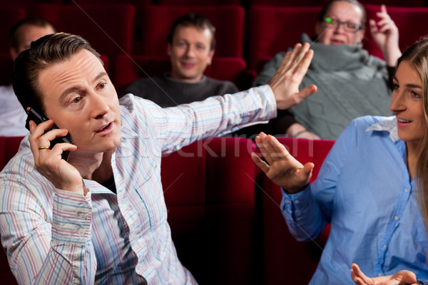 Stock photo: people in cinema theater with mobile phone