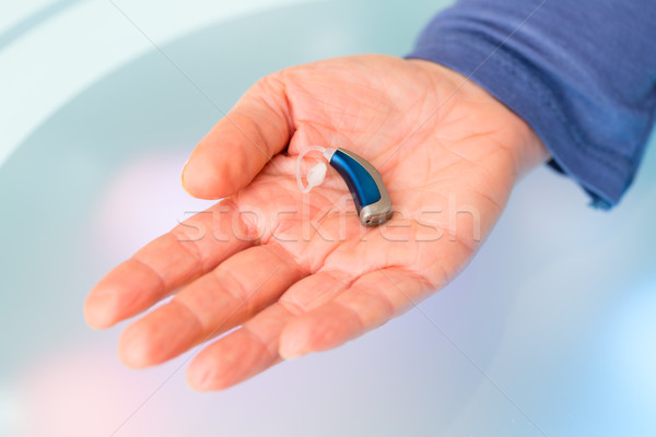 Hand holding hearing aid Stock photo © Kzenon