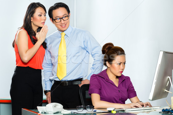 Asian colleagues mobbing or bullying employee Stock photo © Kzenon
