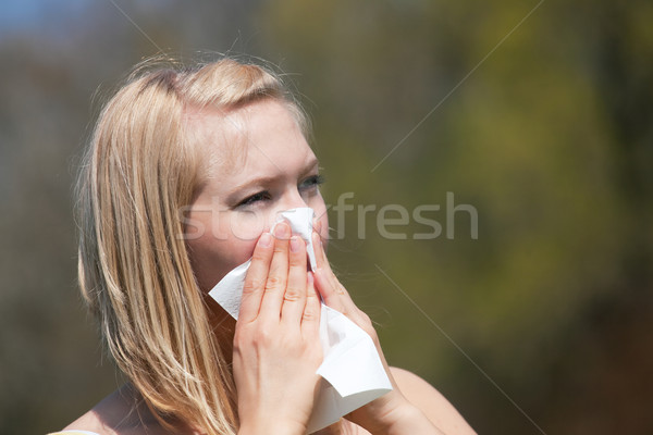 Woman with allergy sneezing Stock photo © Kzenon
