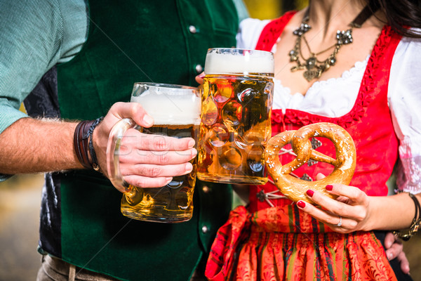 Hands holding Beer and Pretzels, detail of bavarian Tracht  Stock photo © Kzenon