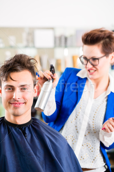 Hairdresser cutting man hair in barbershop Stock photo © Kzenon