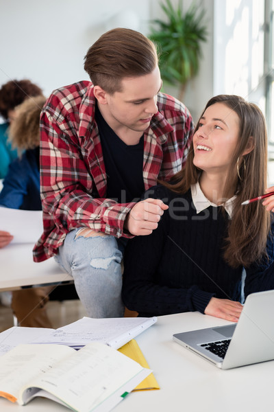 Two cheerful millennial students laughing while sitting together Stock photo © Kzenon