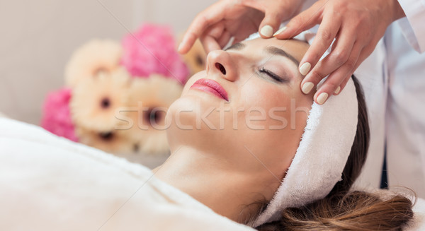 Stock photo: Beautiful woman relaxing during rejuvenating facial massage in a