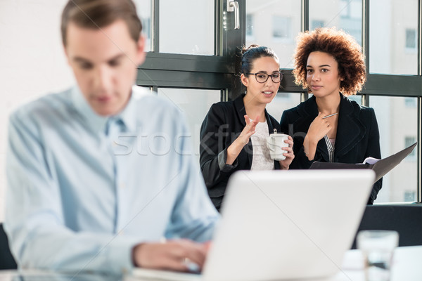 Stock photo: Two young cheerful female employees talking in the office