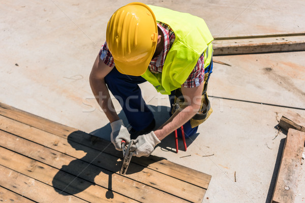 High-angle view of a blue-collar worker using a hammer Stock photo © Kzenon