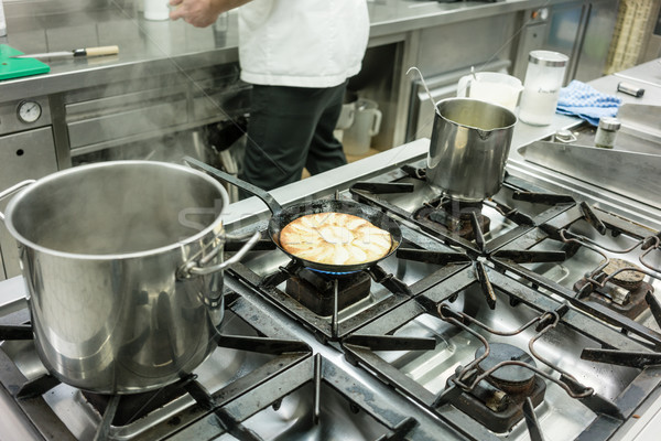 Apple pie in pan on stove in restaurant kitchen Stock photo © Kzenon