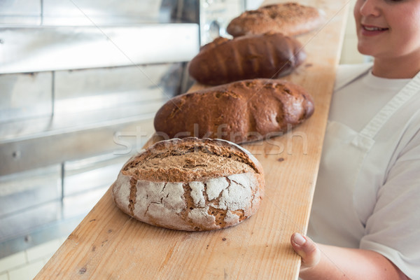 Fresh bread on a board in bakehouse of bakery Stock photo © Kzenon