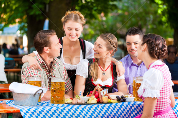 In Beer garden - friends on a table with beer Stock photo © Kzenon