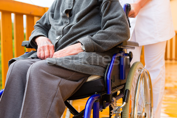 Young nurse and female senior in a wheel chair Stock photo © Kzenon