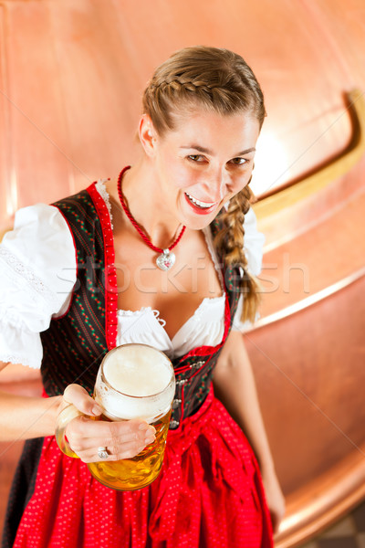 Stock photo: Woman with beer glass in brewery