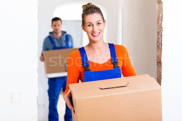 Woman and man moving in new home with boxes Stock photo © Kzenon