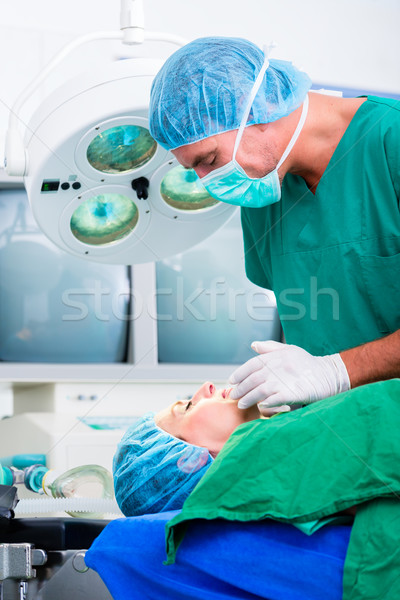 Doctor surgeon with patient in operating room Stock photo © Kzenon
