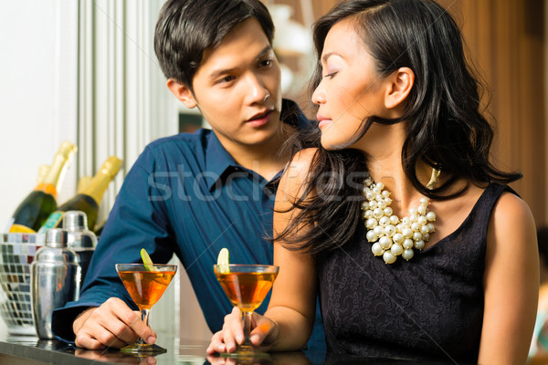 Man and woman in asia at bar with cocktails Stock photo © Kzenon