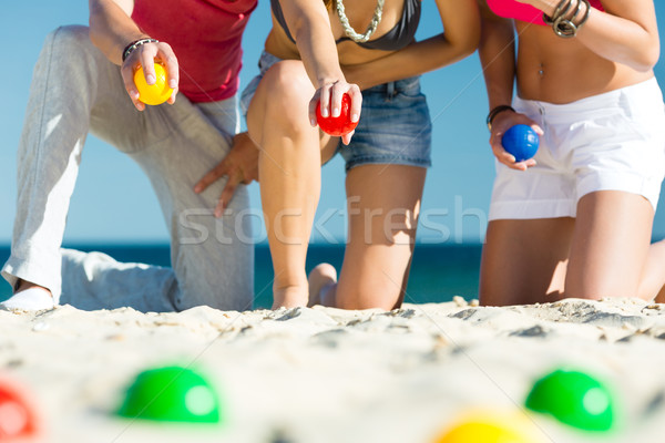 Man and women playing boule on beach Stock photo © Kzenon