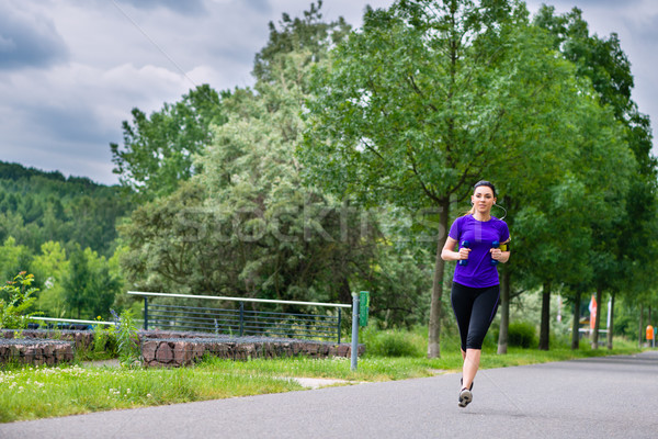 Sports outdoor - young woman running in park Stock photo © Kzenon