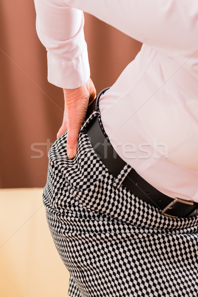Senior having back pain at home Stock photo © Kzenon