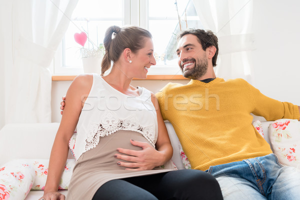 Parents-to-be smiling happily at each other Stock photo © Kzenon
