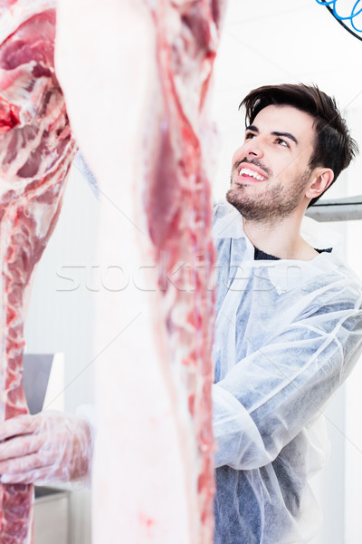 Butcher cutting pork in butchery Stock photo © Kzenon