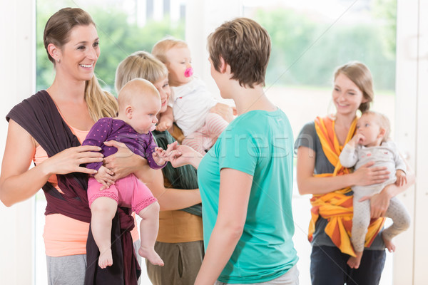 Stock photo: Group of women learning how to use baby slings for mother-child 