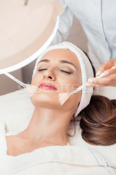 Beautiful woman during anti-aging facial massage in a modern cos Stock photo © Kzenon