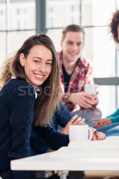 Millennial students watching together an online funny video Stock photo © Kzenon