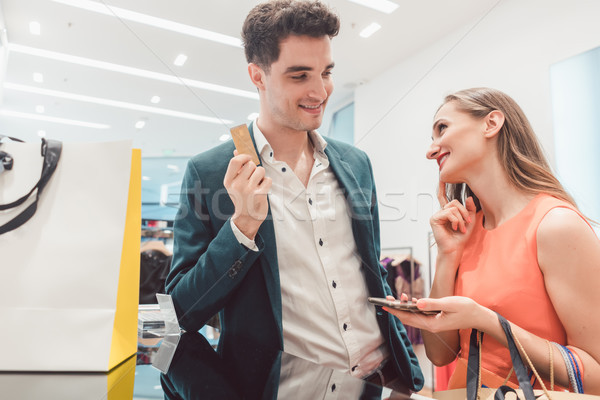 Man having to pay with credit card for fashion items for his wife Stock photo © Kzenon