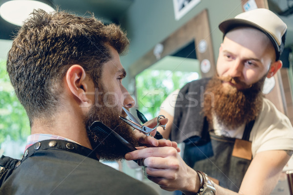 Close-up of the head of a young man and the hands of a hairstylist Stock photo © Kzenon