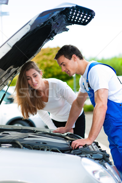 Woman talking to car mechanic in repair shop Stock photo © Kzenon