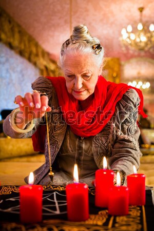 Soothsayer during a Seance or session with pendulum Stock photo © Kzenon