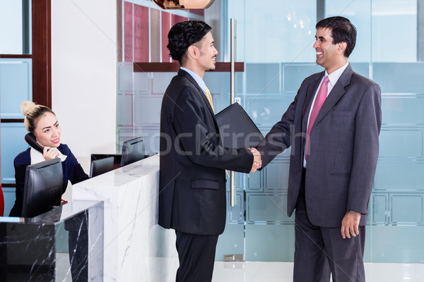 Manager welcoming business associate in office lounge Stock photo © Kzenon