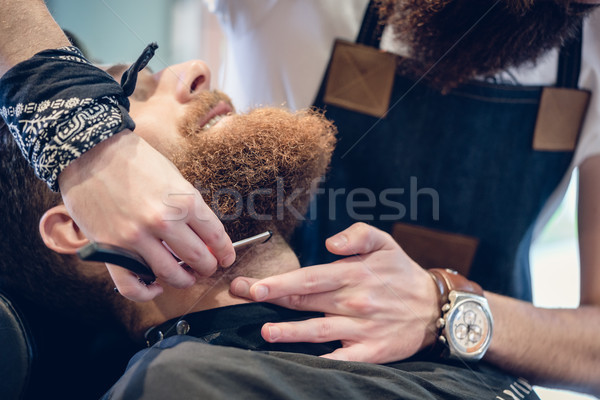 Stock photo: Close-up of the hand of a barber using scissors while trimming