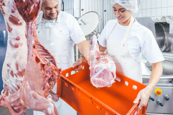 Team of butchers working with meat in butchery Stock photo © Kzenon